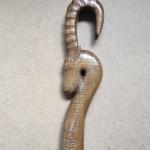 #164 A stick 190 cm high with an goat head and wood carving